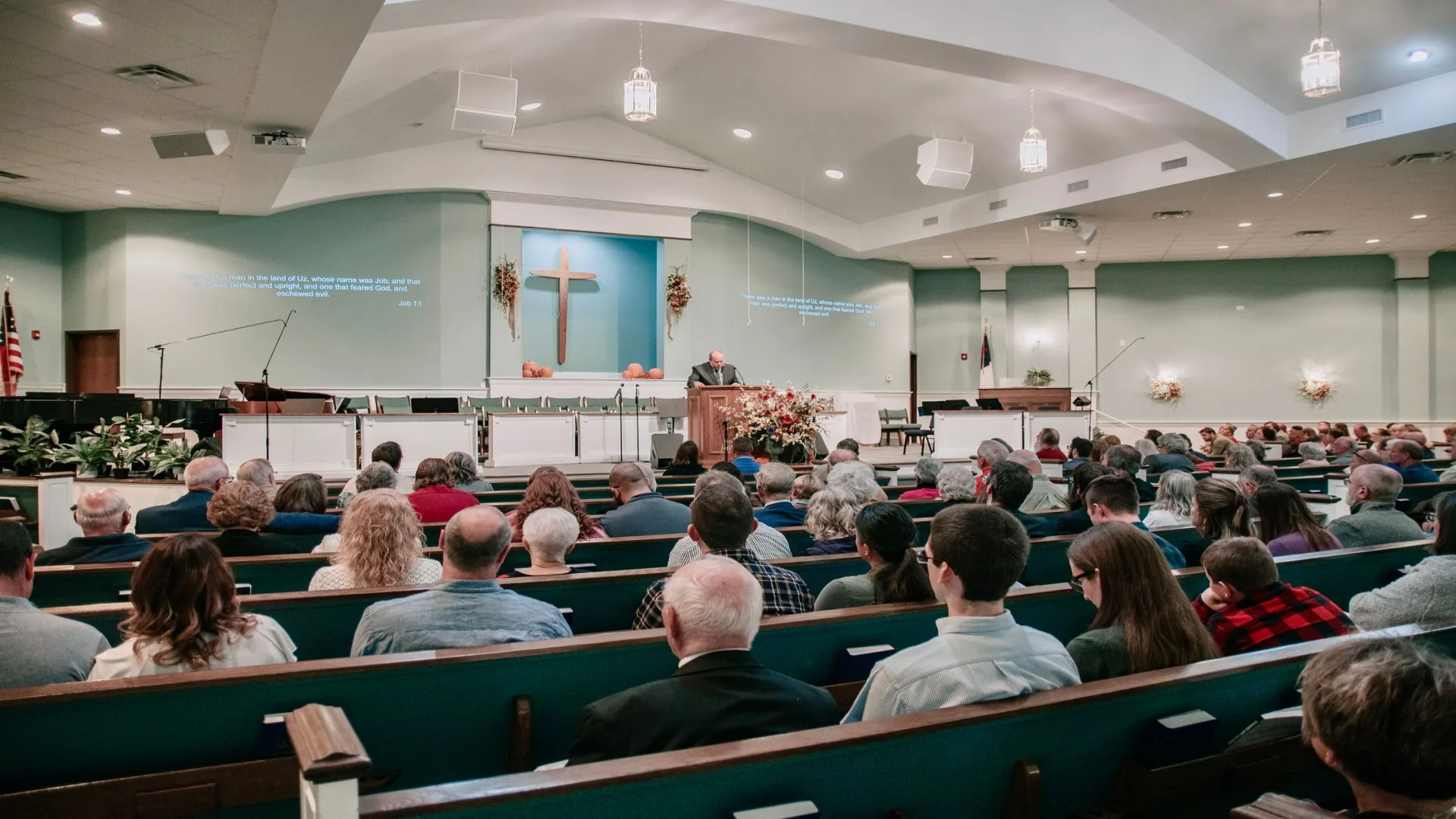 A congregation gathered in warm light during a Sunday worship service at Grace Community Church.