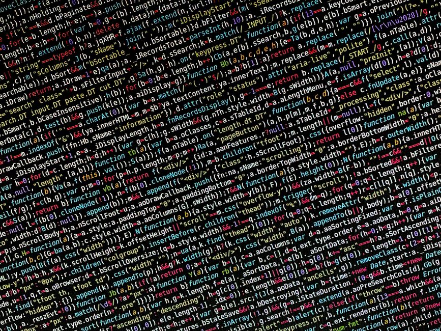 A close-up of a computer screen showing lines of code in a dark editor, with multi-color syntax highlighting.