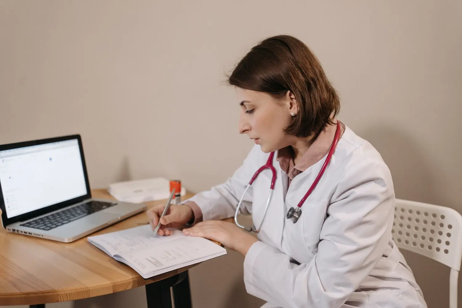 Dr. Sarah Bennett reviewing a patient's chart at her desk at Riverside Family Practice.