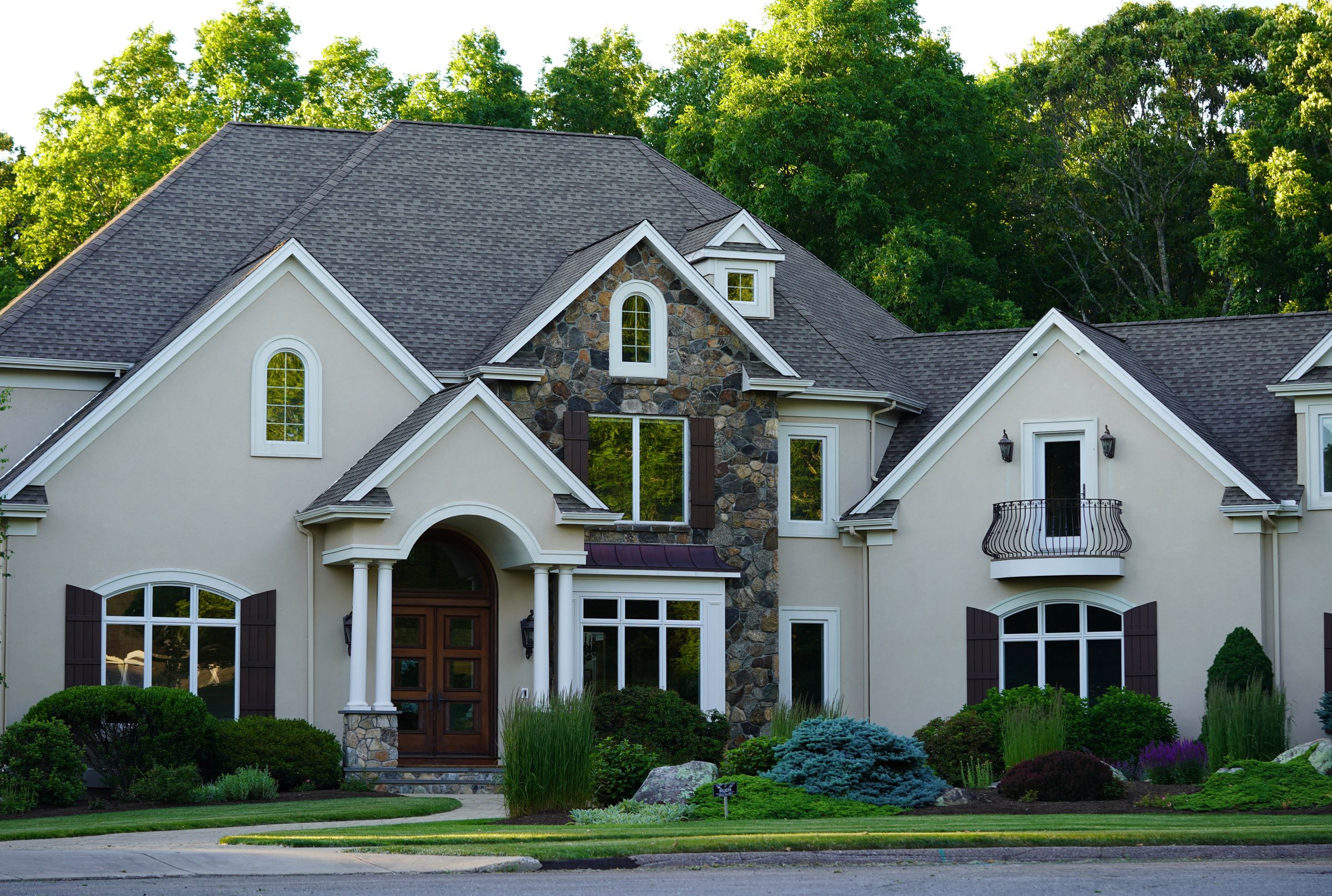 A suburban single-family home with a driveway and front lawn.