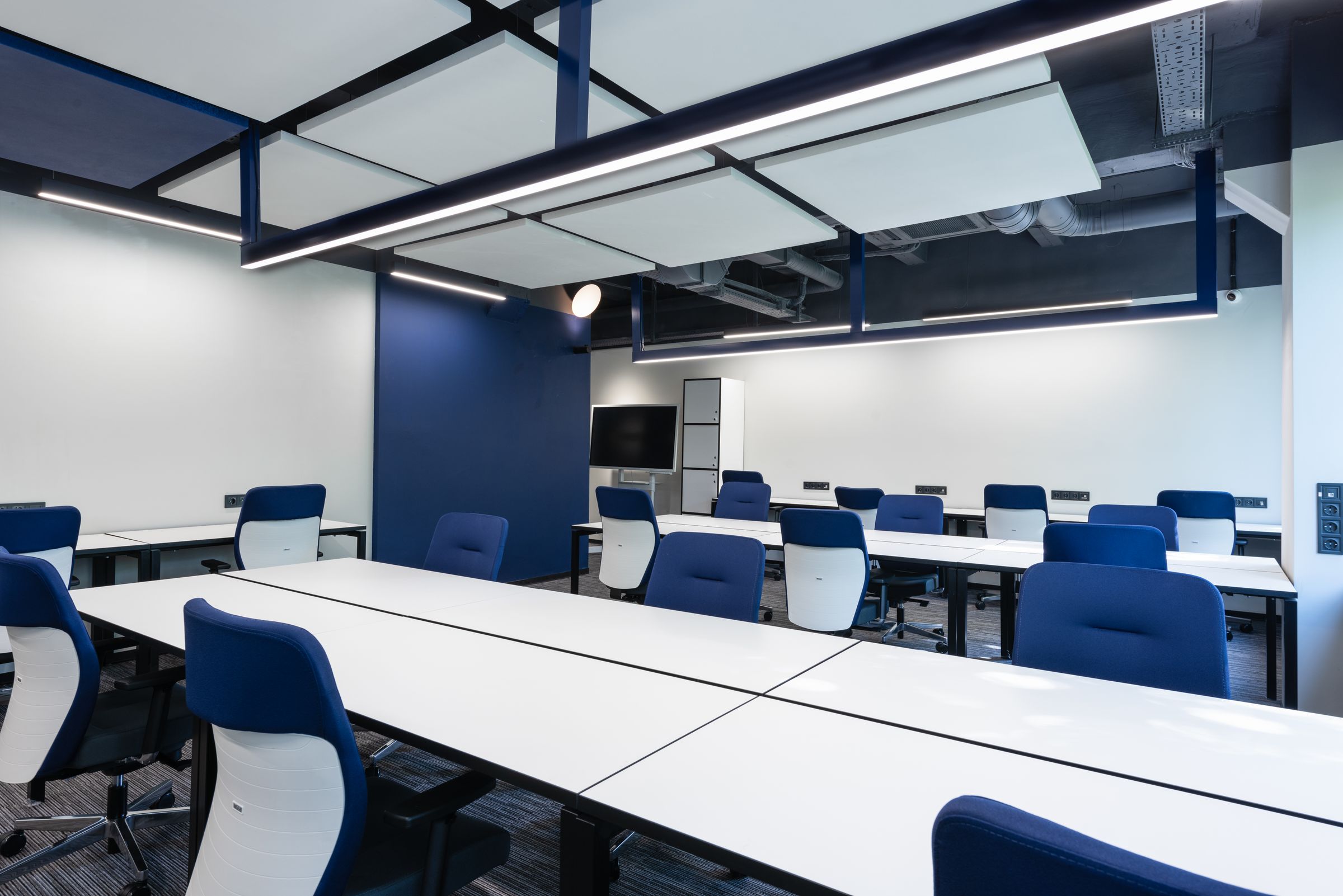 An empty commercial office space with a polished floor and neutral walls.