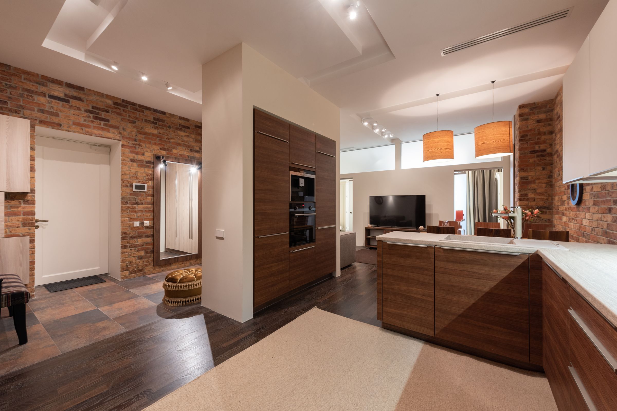 A modern one-bedroom apartment interior with an open living and kitchen area.