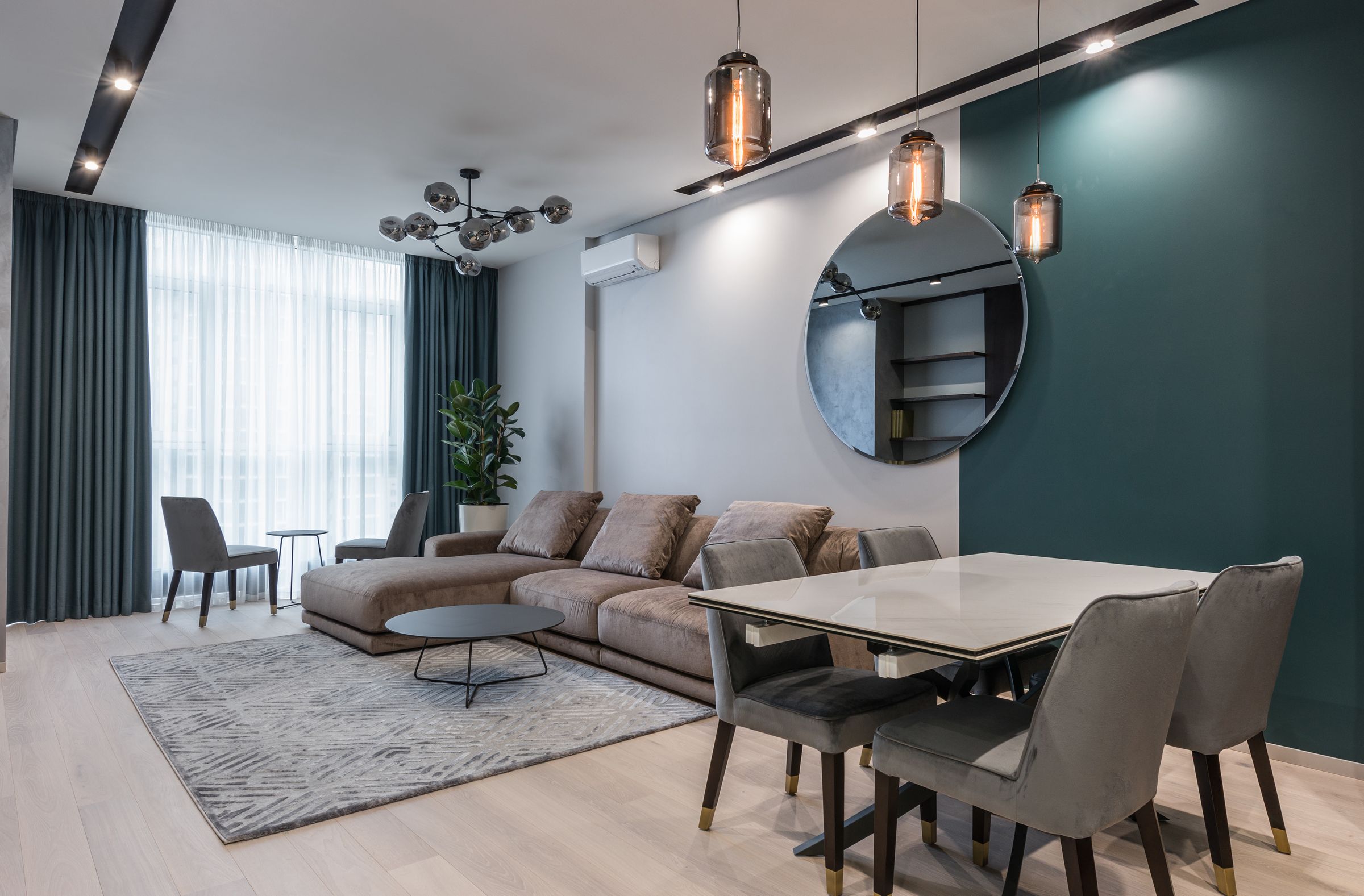 A bright, modern apartment living room with neutral furnishings.