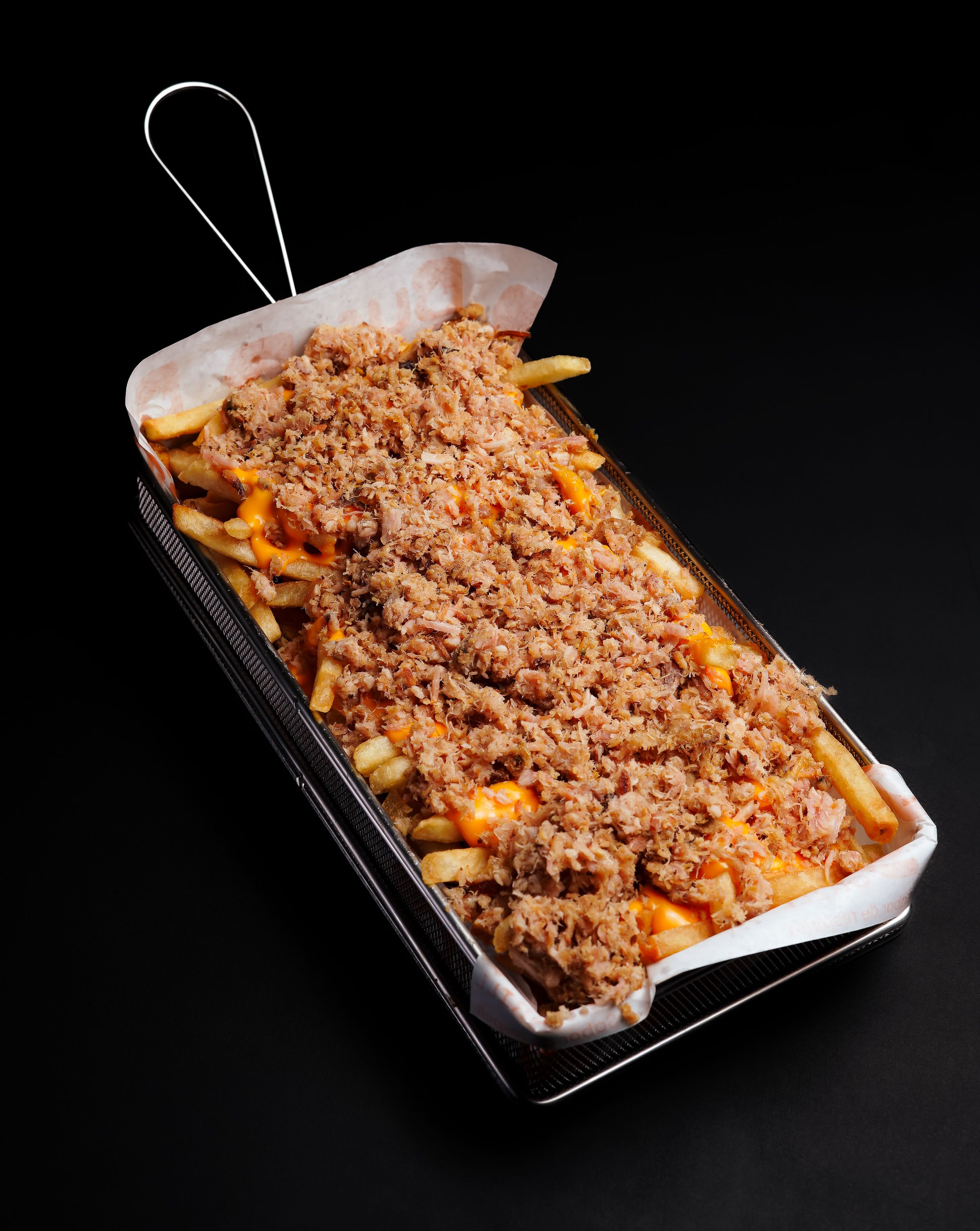 Loaded fries piled with pulled pork and melted cheddar at The Steel Hearth.