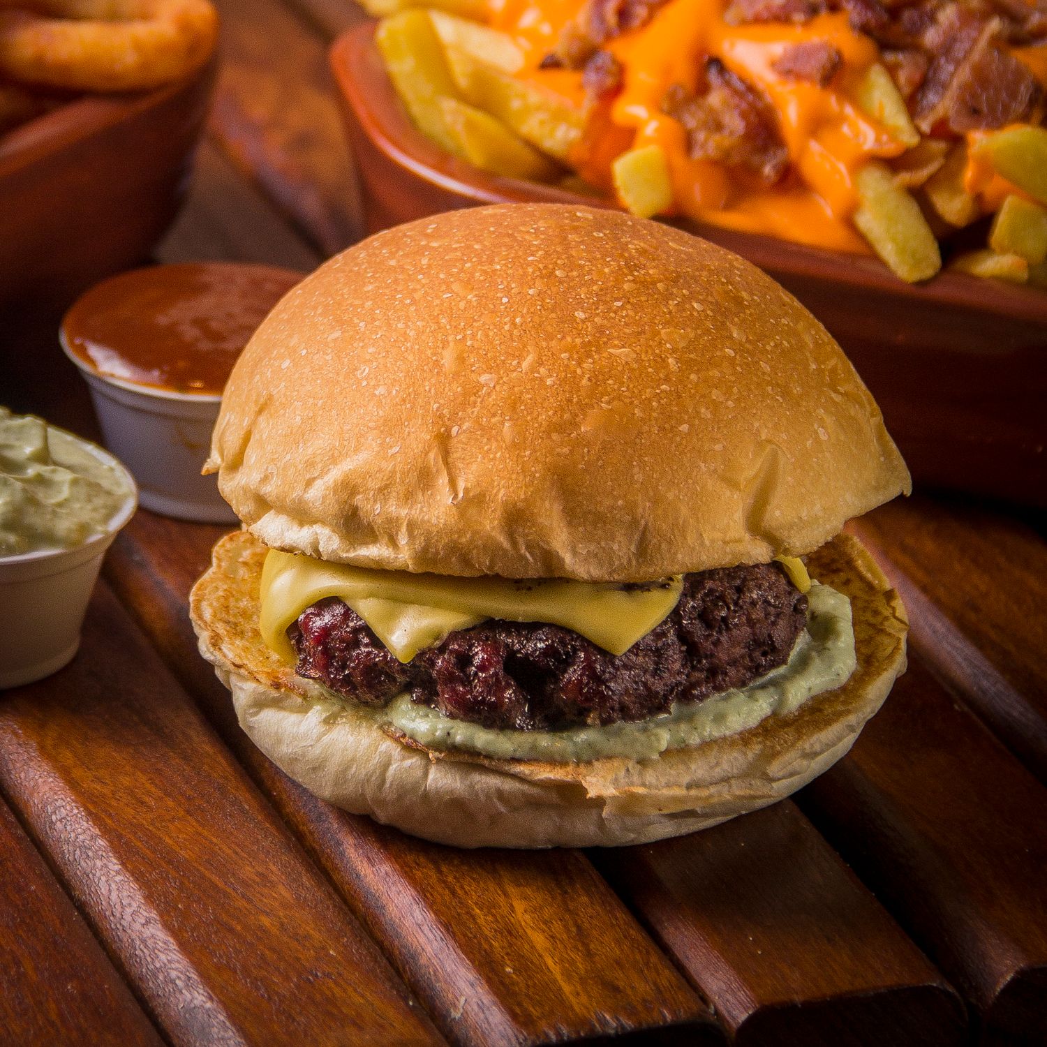 Close-up of a gourmet burger on a wooden board at The Steel Hearth.